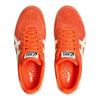 The top view of the orange sneakers that displays the breathability in the insoles.