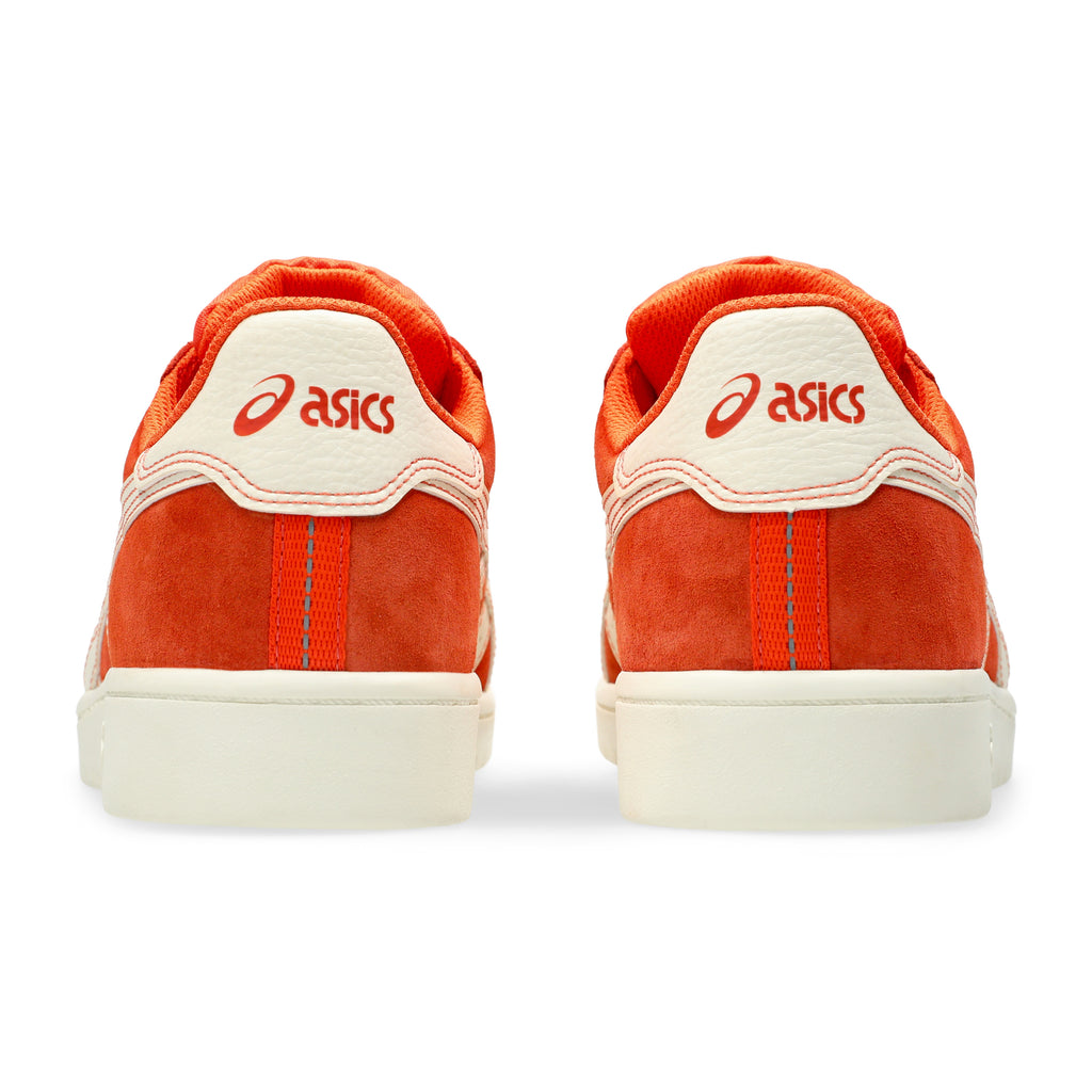 The back view of a pair of shoes that displays "asics" with the logo on the heel tabs.