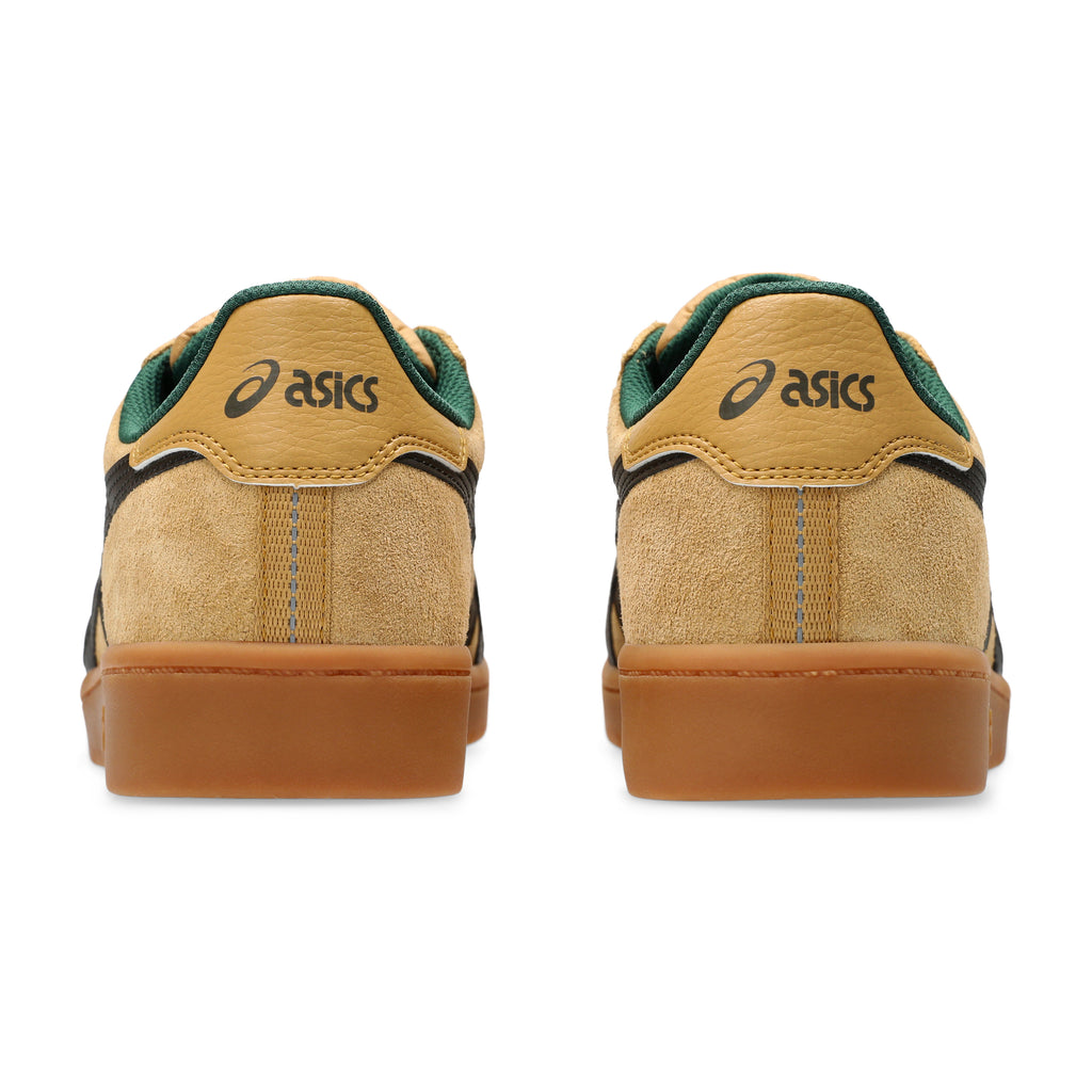 A pair of ASICS JAPAN PRO WOOD THRUSH / BLACK COFFEE sneakers, featuring a tan and green color scheme with gum soles, crafted from durable suede, seen from the back.