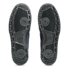 The image displays the soles of a pair of black skateboarding shoes featuring a textured pattern and circular grips, reflecting the robust footwear design characteristic of models such as the ASICS JAPAN PRO PEACOAT / BLACK.