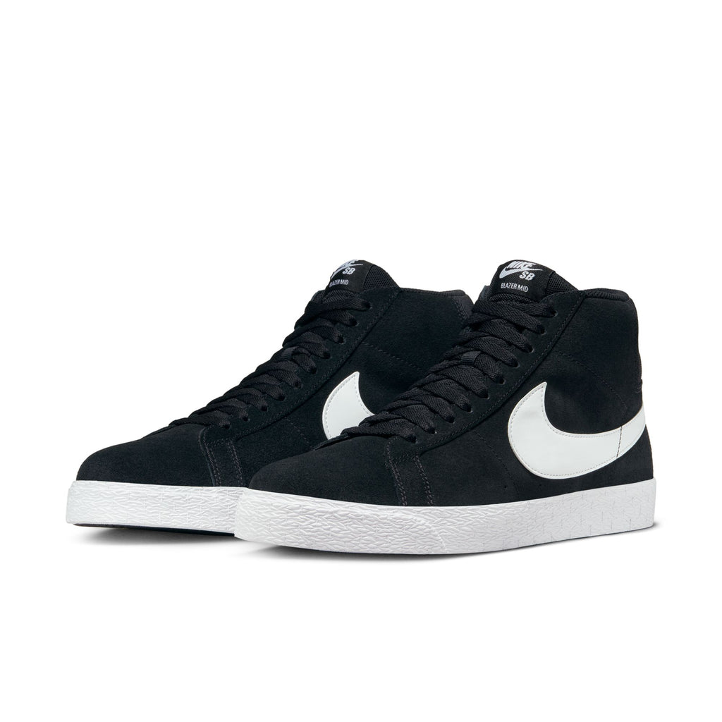 A pair of black nike NIKE SB BLAZER MID BLACK / WHITE high-top sneakers with white soles and white swoosh logos on the sides, featuring Zoom Air cushioning designed for skateboarding.