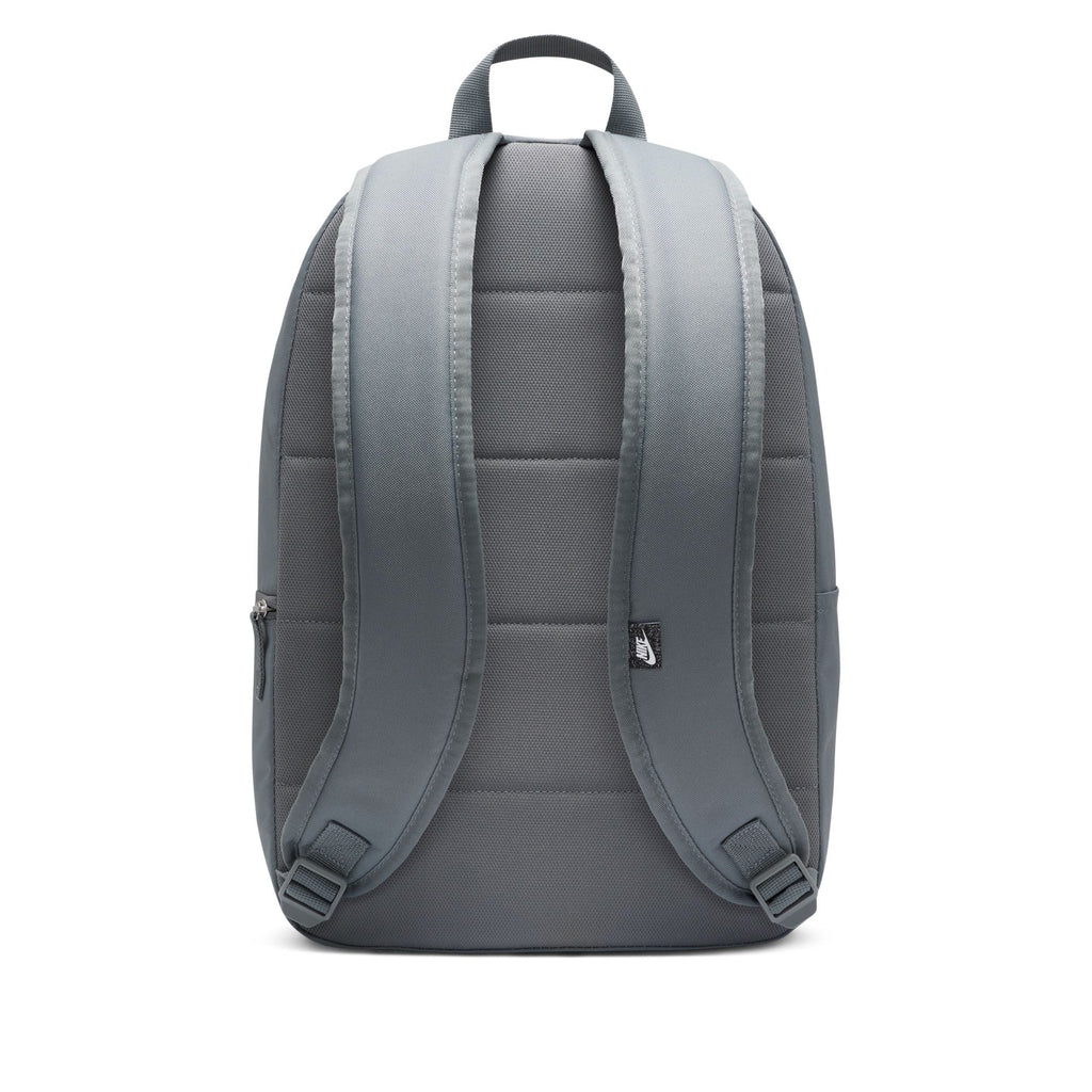 The NIKE HERITAGE BACKPACK in Smoke Grey/White offers padded shoulder straps, a top handle, and a laptop sleeve. Made from recycled polyester, it's ideal for eco-conscious adventurers with its sleek back view and functional design.