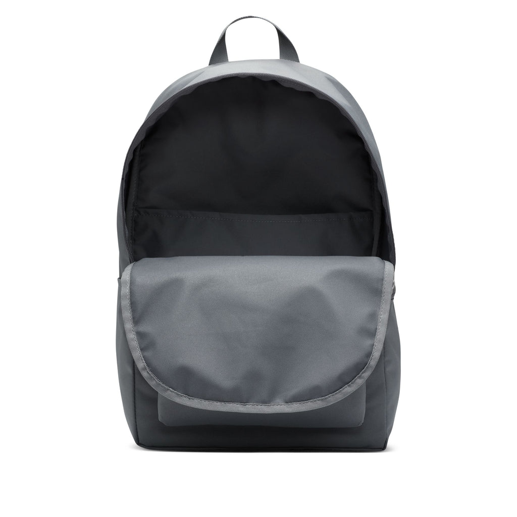 The NIKE HERITAGE BACKPACK in Smoke Grey features a sleek design made from recycled polyester, offering an open main compartment, front pocket, and laptop sleeve.
