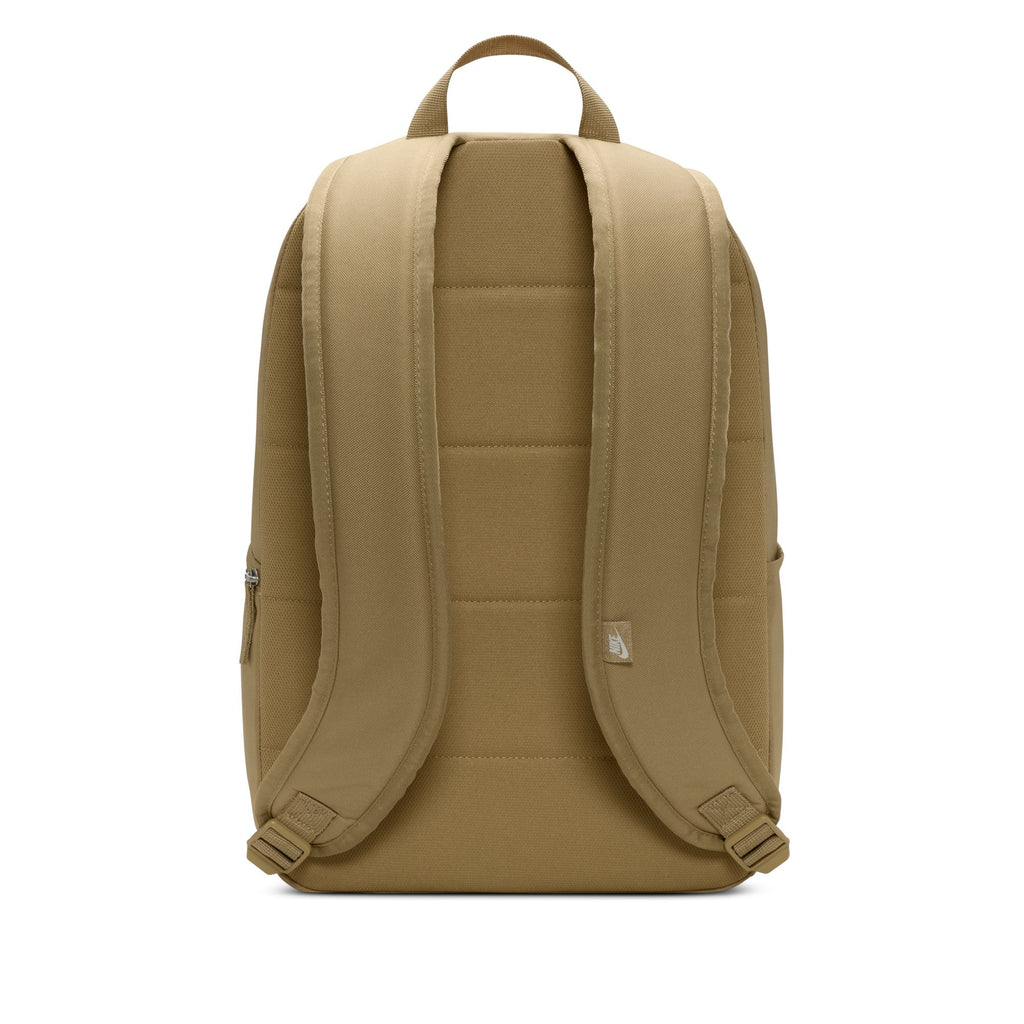 The NIKE HERITAGE BACKPACK in Parachute Beige/Summit White has padded shoulder straps, a top handle, and is made from recycled polyester. It includes a 15" laptop sleeve for added convenience and is viewed from the back.