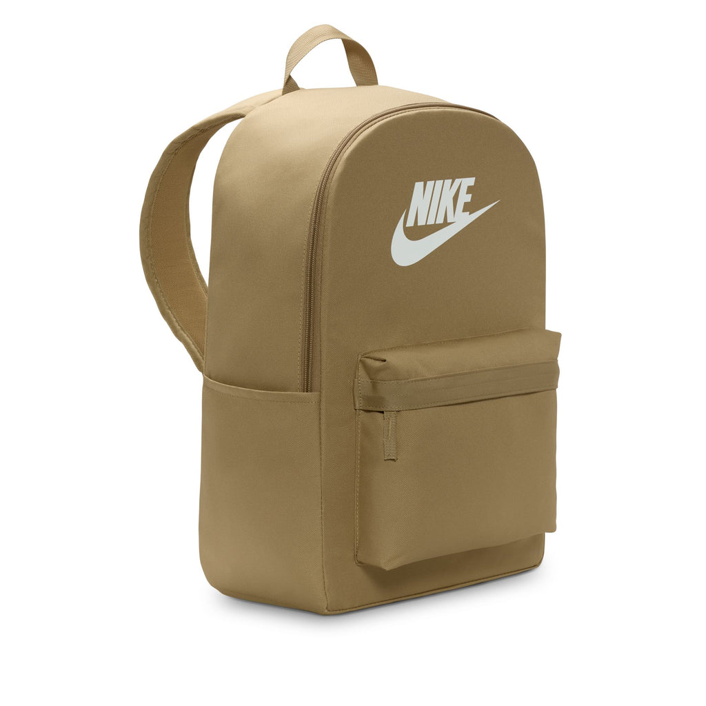 The Nike Heritage Backpack in Parachute Beige/Summit White, made from recycled polyester, features a sleek white logo, front zip pocket, dual shoulder straps, and a 15" laptop sleeve for enhanced functionality.