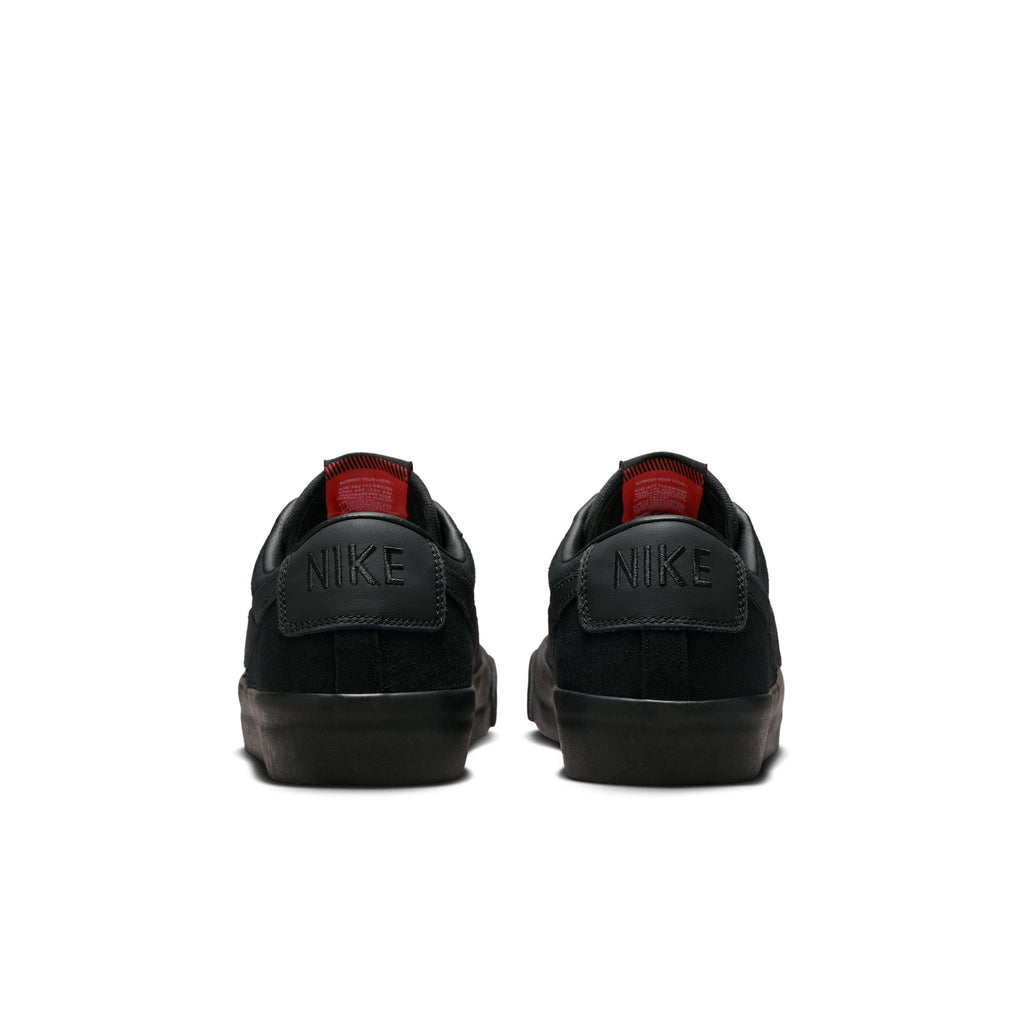 Rear view of the NIKE SB BLAZER LOW PRO GT in Black, showcasing sleek black tones with subtle red accents and featuring the iconic Nike logo on the back, ideal for skateboarding enthusiasts in Columbia, SC.