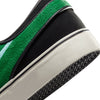 A black and green NIKE SB ZOOM JANOSKI OG+ GORGE GREEN / ACTION GREEN sneaker with a white sole.