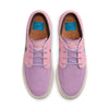 The top view of the purple and pink paneled shoes with cork designed insoles with the nike logo on them.
