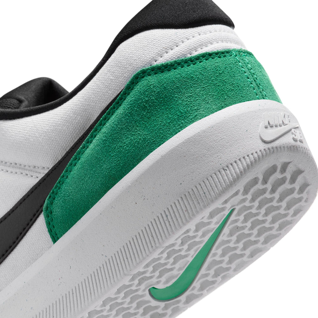 Close-up of the heel of a NIKE SB FORCE 58 in white with stadium green suede detail and black accents; features the nike logo on the sole and heel, reflecting its basketball heritage and durability.