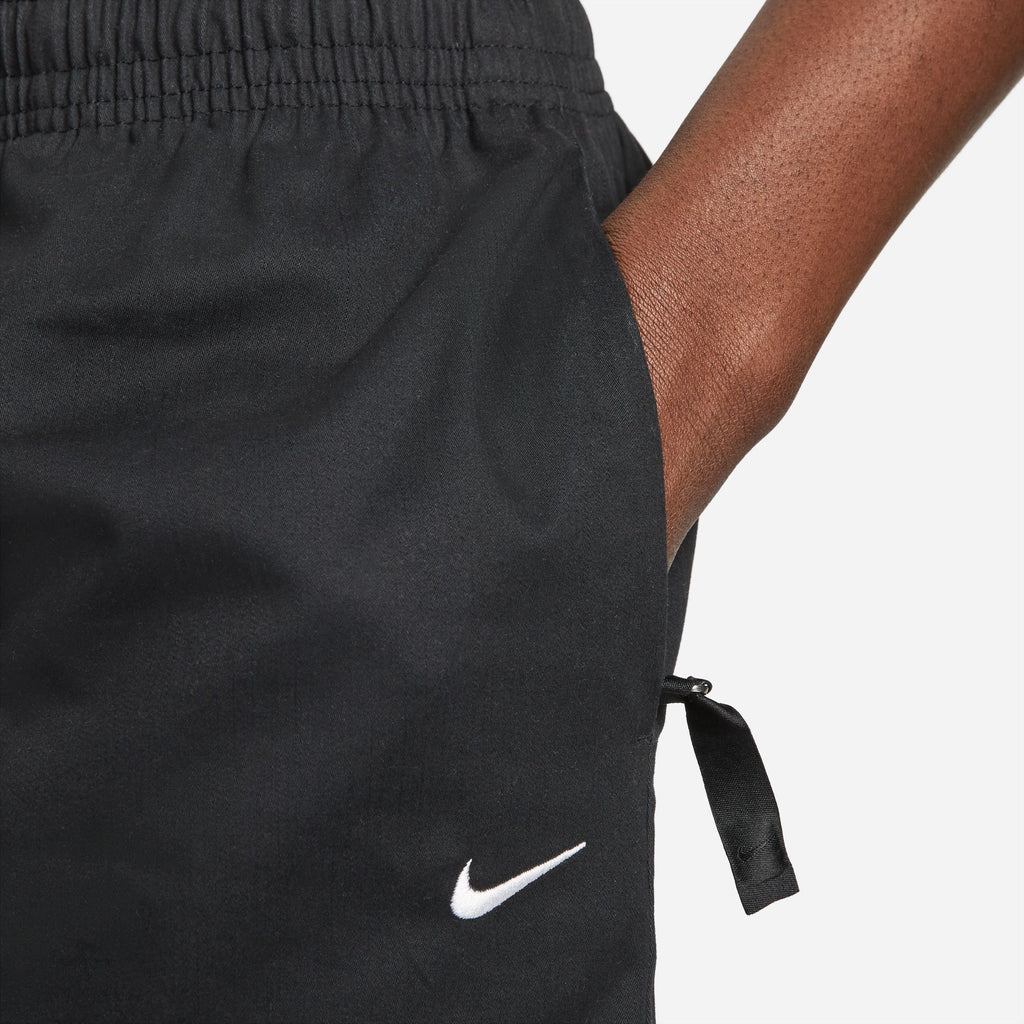 A close up of a person wearing a pair of Nike SB Skyring Skate Shorts Loose Fit Black.