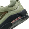 Close-up of an olive green and black nike NIKE SB ISHOD 2 AIR MAX OIL GREEN/OIL GREEN athletic shoe showing details of the material, stitching, and clear Air Max technology in the sole.