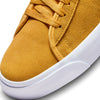A pair of yellow Nike SB Blazer Mid Pro GT University Gold / Game Royal sneakers with white soles, perfect for skateboard enthusiasts like Grant Taylor.