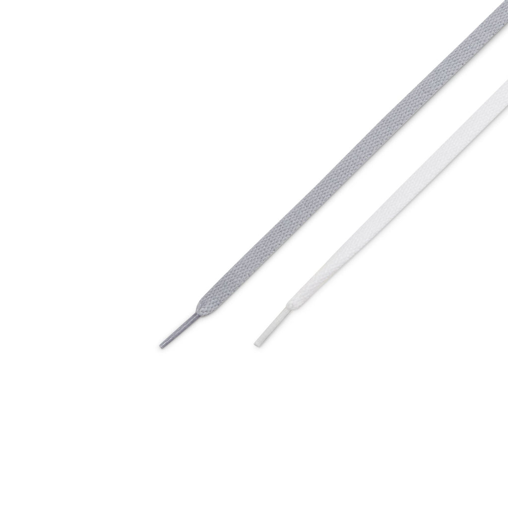 Close-up of two shoelace ends, one gray and one white, laid side by side on a white background, reminiscent of the laces from the NIKE SB BLAZER MID WOLF GREY / MIDNIGHT NAVY often favored by skateboarders.