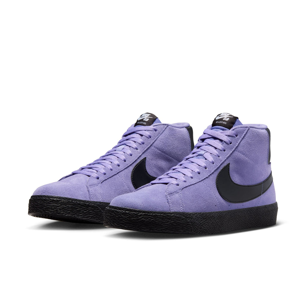 The NIKE SB BLAZER MID DUSTY AMETHYST / BLACK-DUSTY AMETHYST by Nike features purple high-top sneakers with black swooshes and soles, shown from the front. Ideal for skaters, these include Zoom Air cushioning for comfort and style.