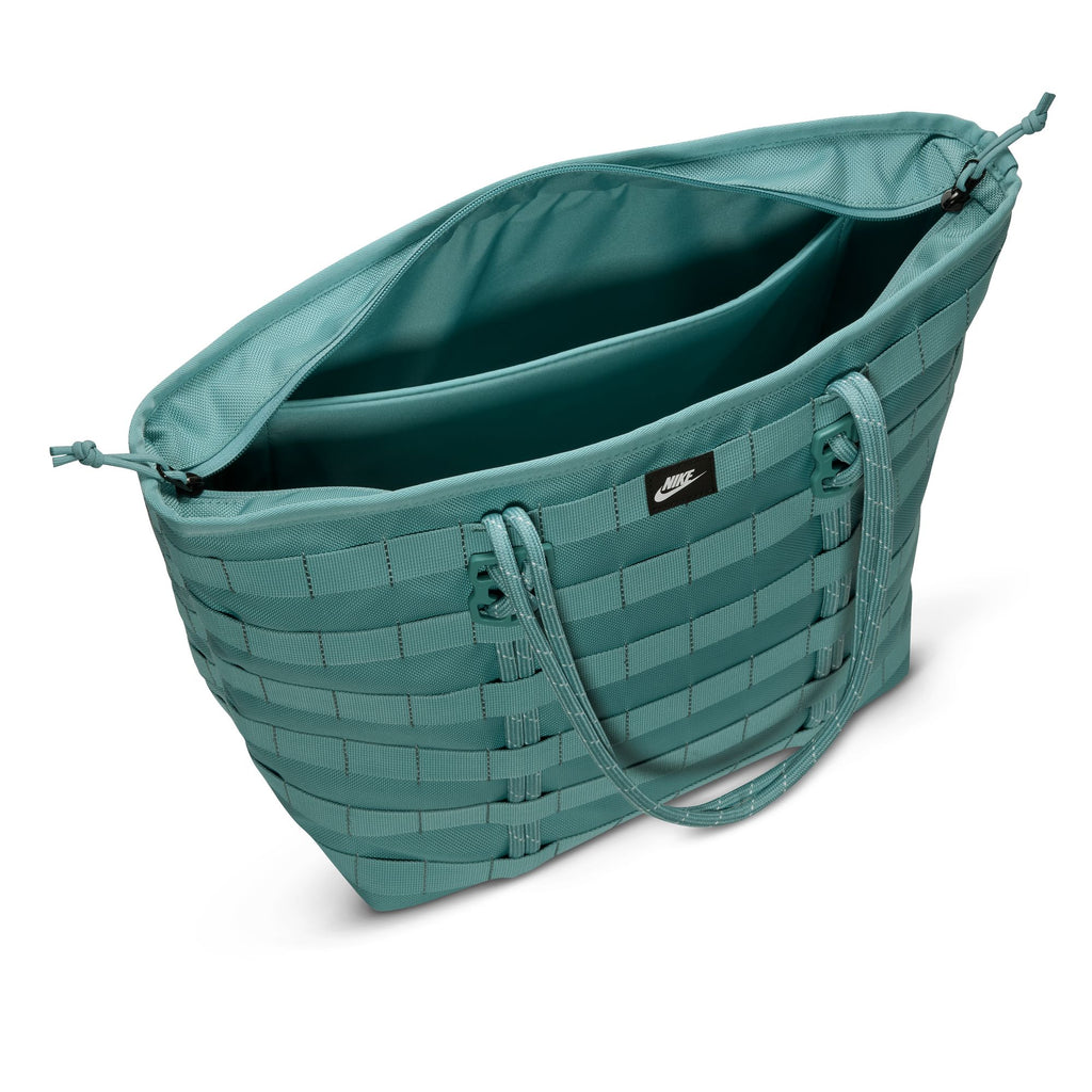 The NIKE RPM TOTE (26L) in denim turquoise/black/summit white features double handles, an open top, a roomy interior for essentials or a laptop, and a small front nike logo.