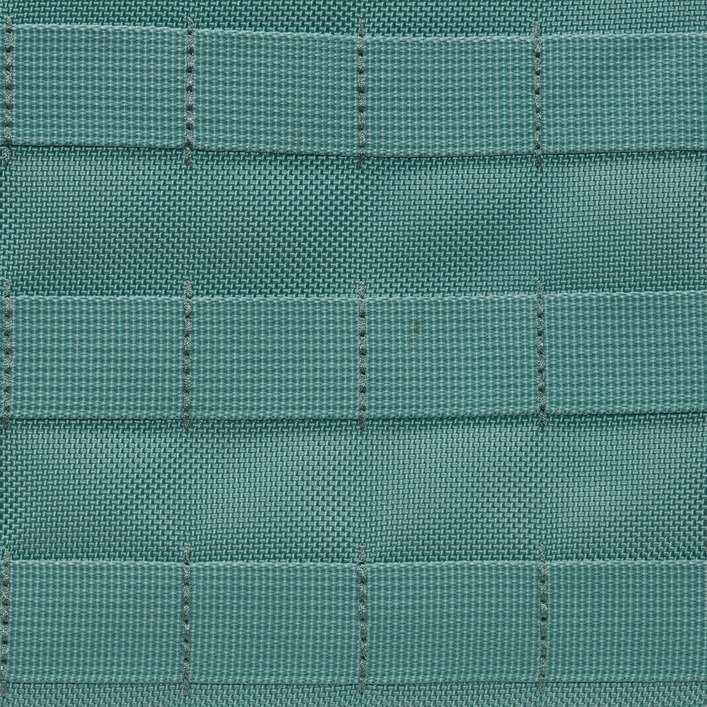 Close-up of the NIKE RPM TOTE (26L) in Denim Turquoise/Black/Summit White, featuring teal woven fabric with a grid pattern and textured horizontal and vertical stitching.