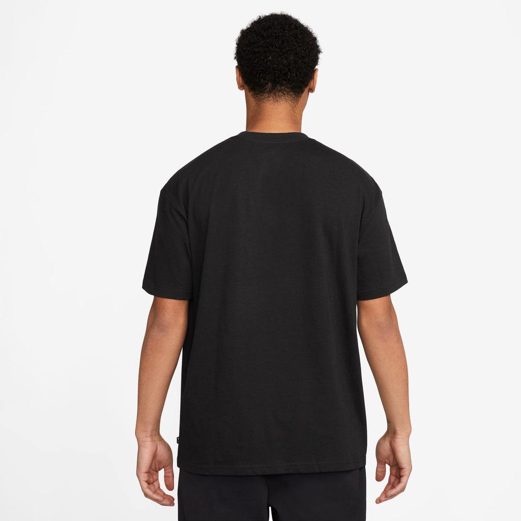 The back view of a man wearing a black NIKE SB 'SPORTS GUY' SKATE TEE BLACK.