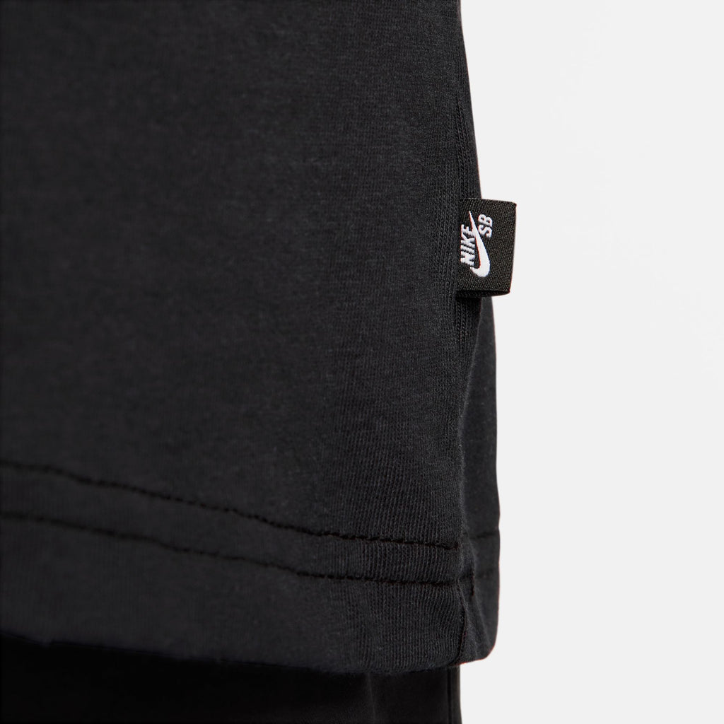 A close up of a black NIKE SB 'SPORTS GUY' SKATE TEE BLACK with a nike logo on it.