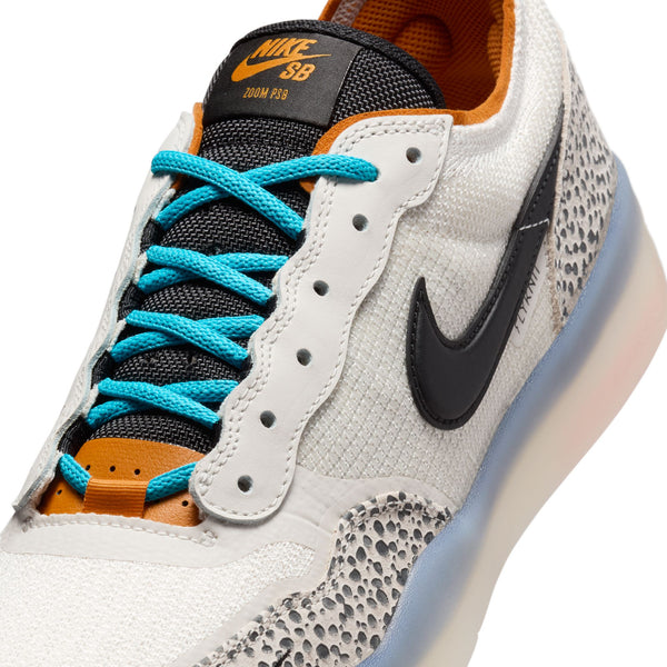 Close-up of a NIKE SB PS8 ELECTRIC PHANTOM/BLACK-FOSSIL-MONARCH sneaker by Nike featuring white textured fabric, black Swoosh logo, blue laces, and a gray speckled pattern near the sole, all powered by Air Zoom cushioning for ultimate comfort.