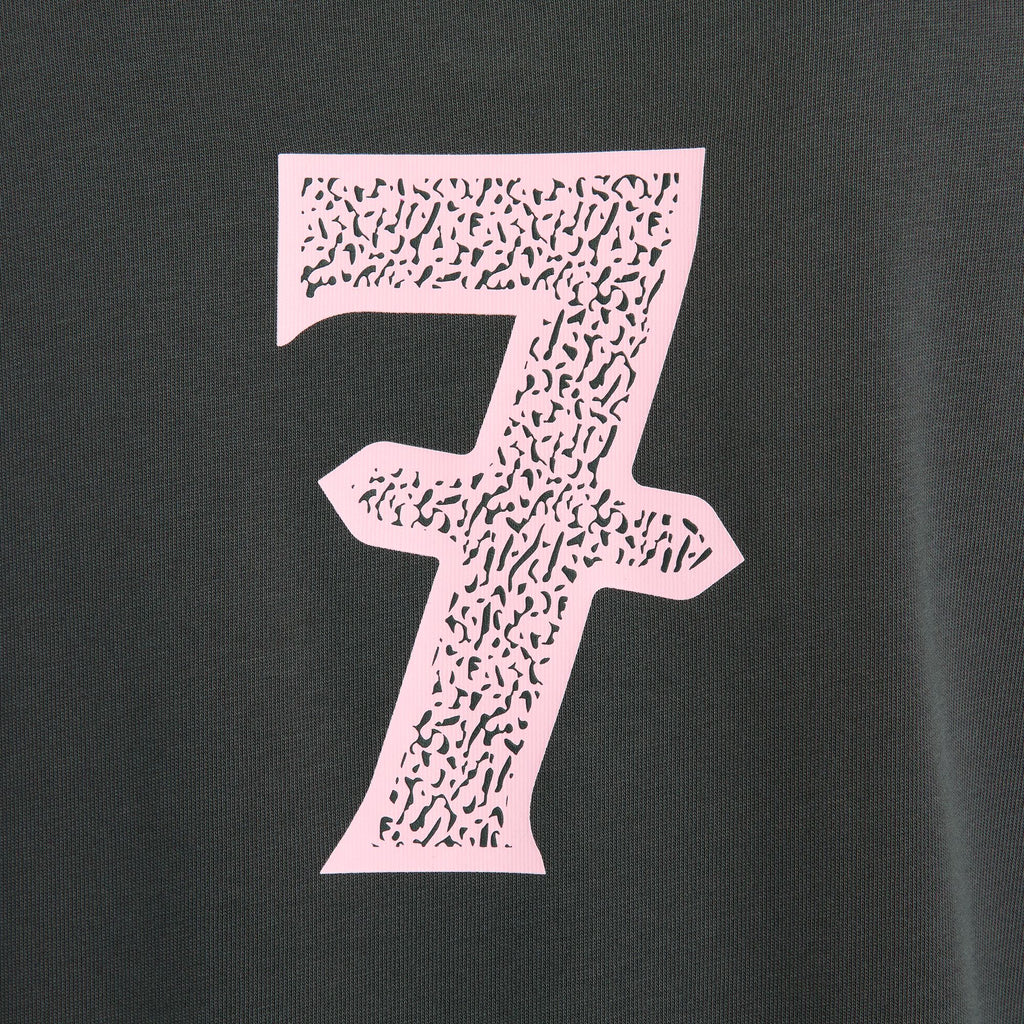 An up close of a pink printed number 7.