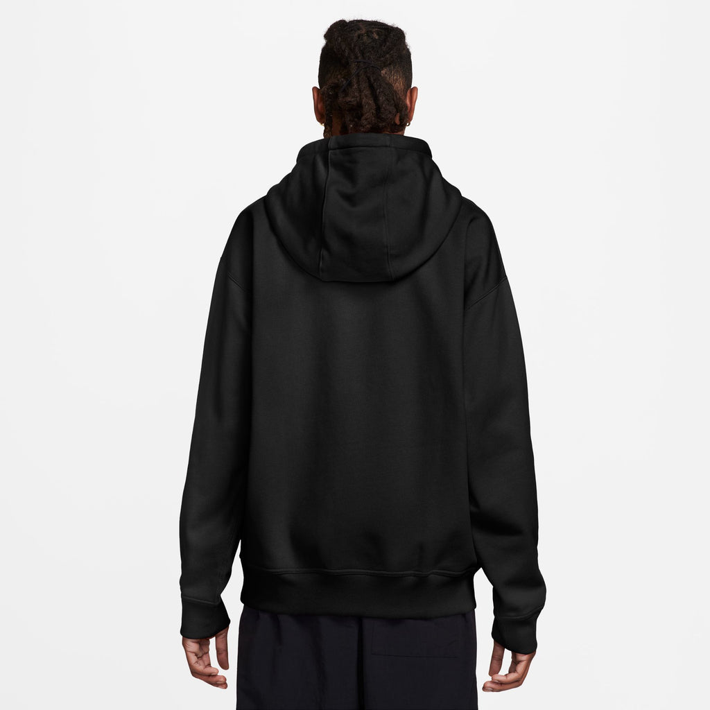 The man is wearing a black Nike SB Embroidered Fleece Hoodie made from brushed fleece.