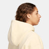 The back view of a woman wearing a NIKE SB 'CITY OF LOVE' FLEECE HOODIE COCONUT MILK.