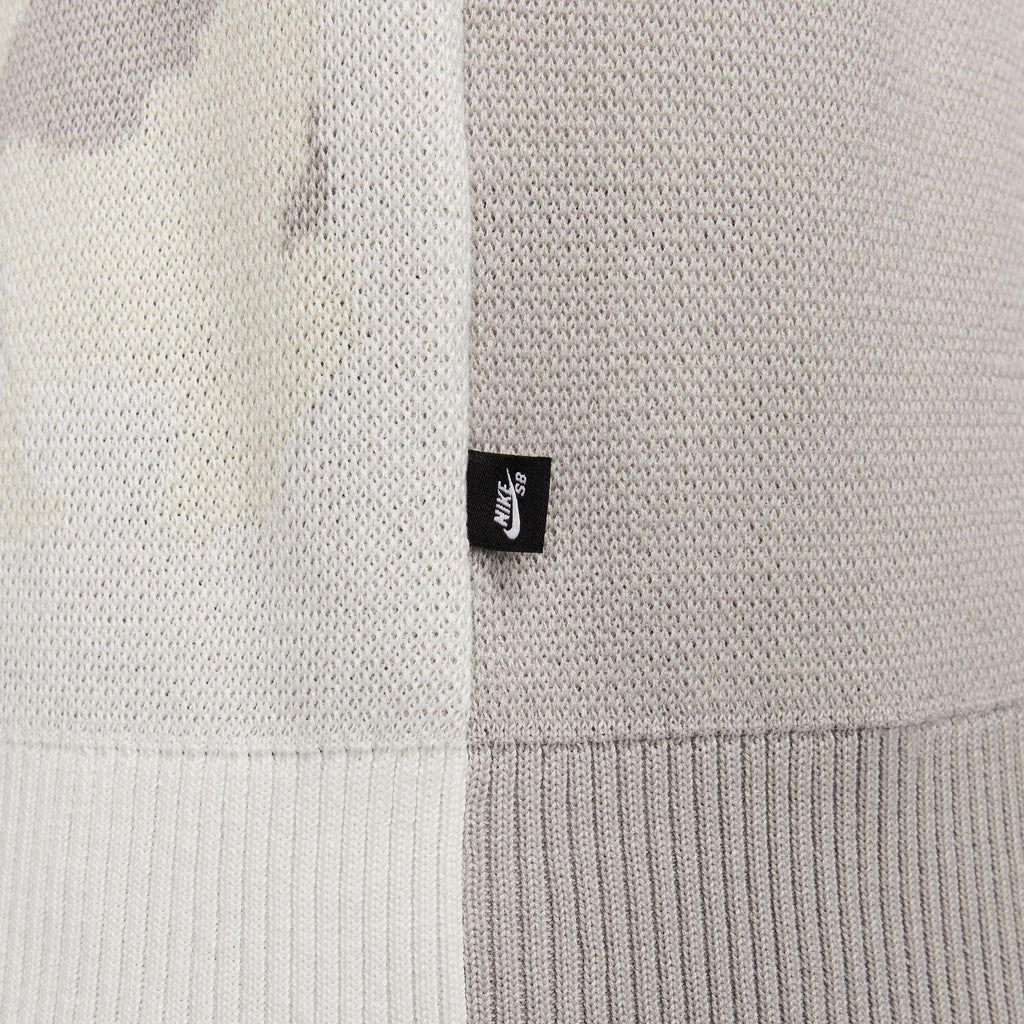 A close up of a nike 'City of Love' knit sweater, featuring a camouflage pattern.