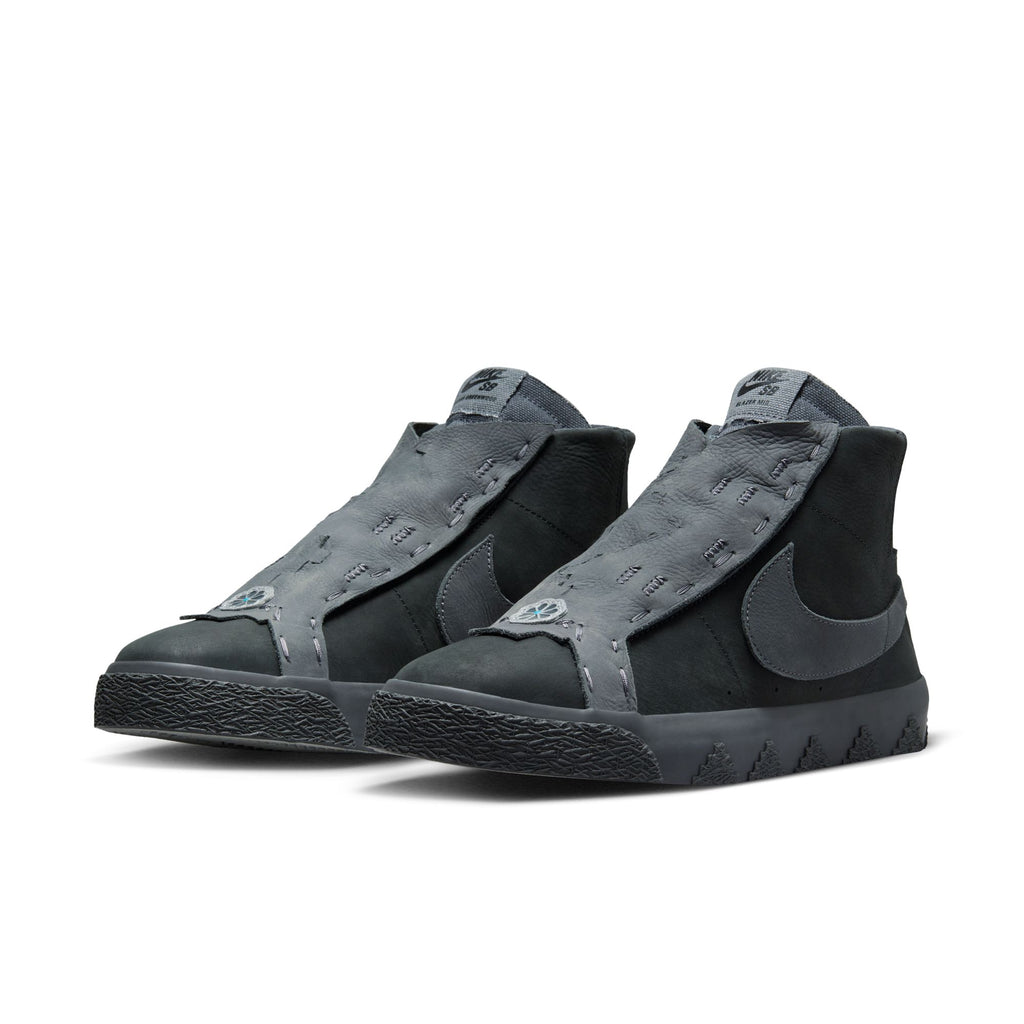 A pair of NIKE SB X DI'ORR GREENWOOD BLAZER MID DECON ANTHRACITE / DARK GREY SMOKE with a large nike swoosh on the side and grey textured detailing, featuring Zoom Air cushioning for added comfort.