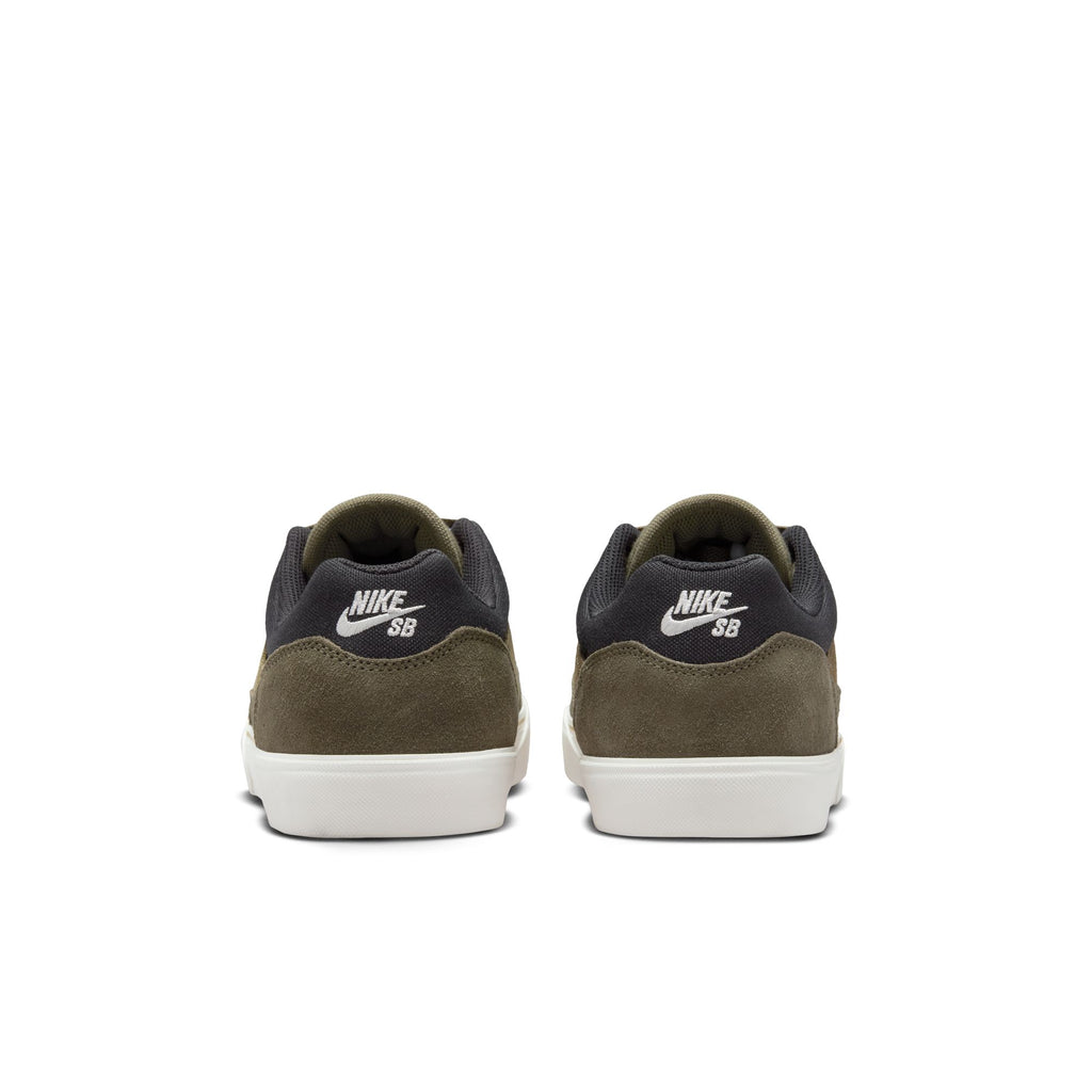 Rear view of the NIKE SB MALOR sneakers, showcasing medium olive suede and black mesh uppers, complemented by white soles and the Nike SB logo in white on the back. Designed for skateboarding, these sneakers provide an ideal blend of style and durability.