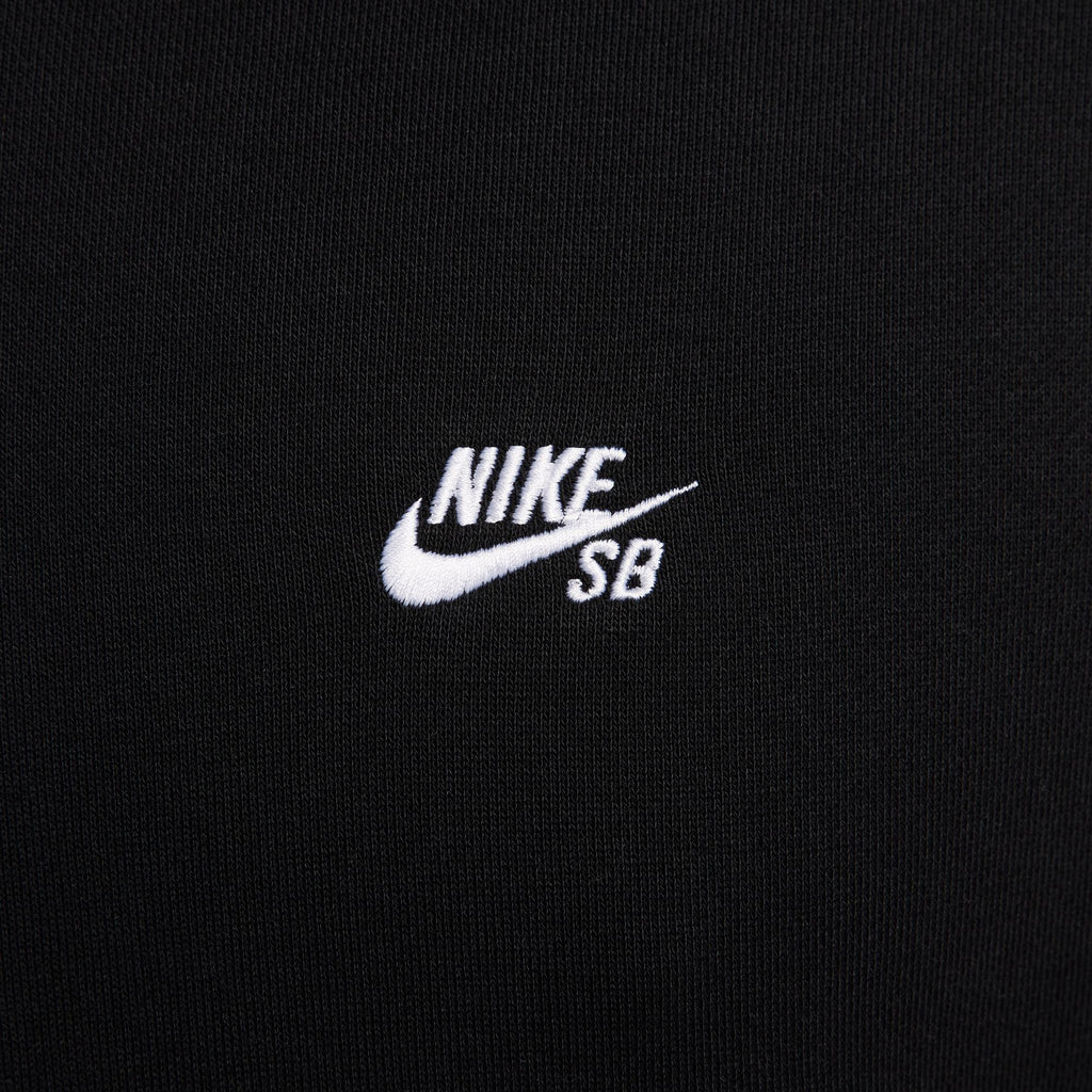 Close-up of the Nike SB Essentials Logo Fleece Hoodie in black, featuring the white embroidered "Nike SB" logo, highlighting the brand's iconic style in the City of Love.