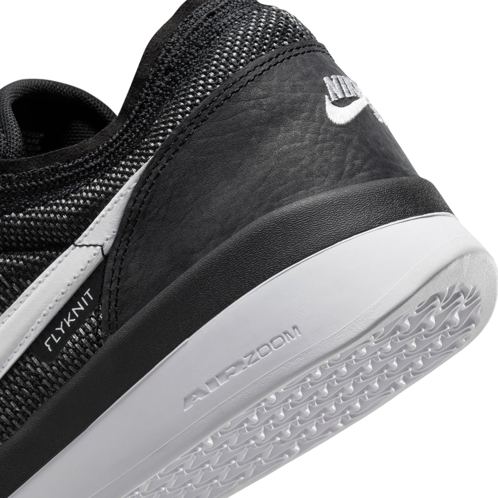 Close-up of NIKE SB PS8 BLACK / WHITE by Nike, featuring its Flyknit upper with contrasting textures and the Air Zoom logo on the sole, emphasizing advanced Air Zoom cushioning for superior comfort.