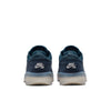 A pair of Nike SB PS8 OBSIDIAN / PHANTOM-SQUADRON BLUE sneakers, featuring Flyknit construction for enhanced breathability, is viewed from the back. Each heel showcases a white Nike swoosh logo against a sleek white background.