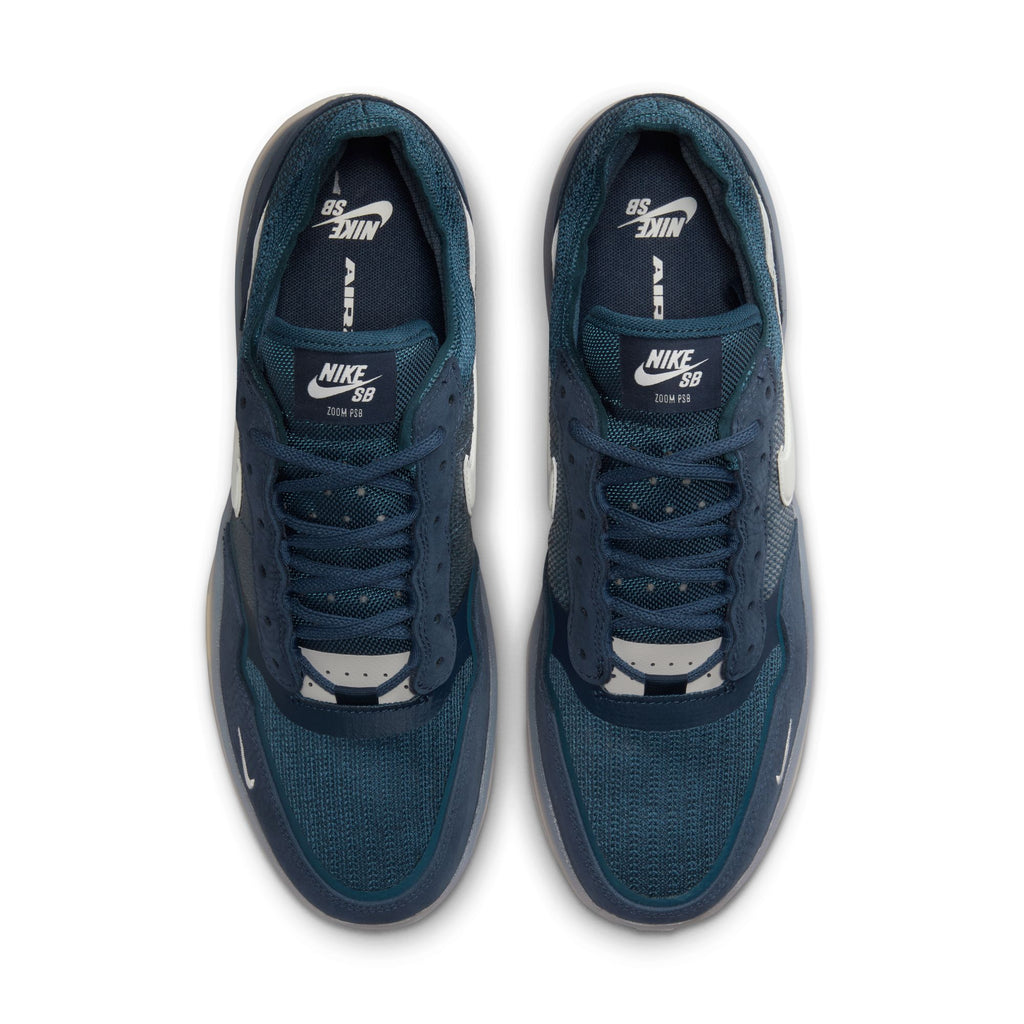 Top view of a pair of obsidian/phantom-squadron blue NIKE SB PS8 sneakers, featuring white logos on the tongue and side, enhanced by Air Zoom cushioning for superior comfort.