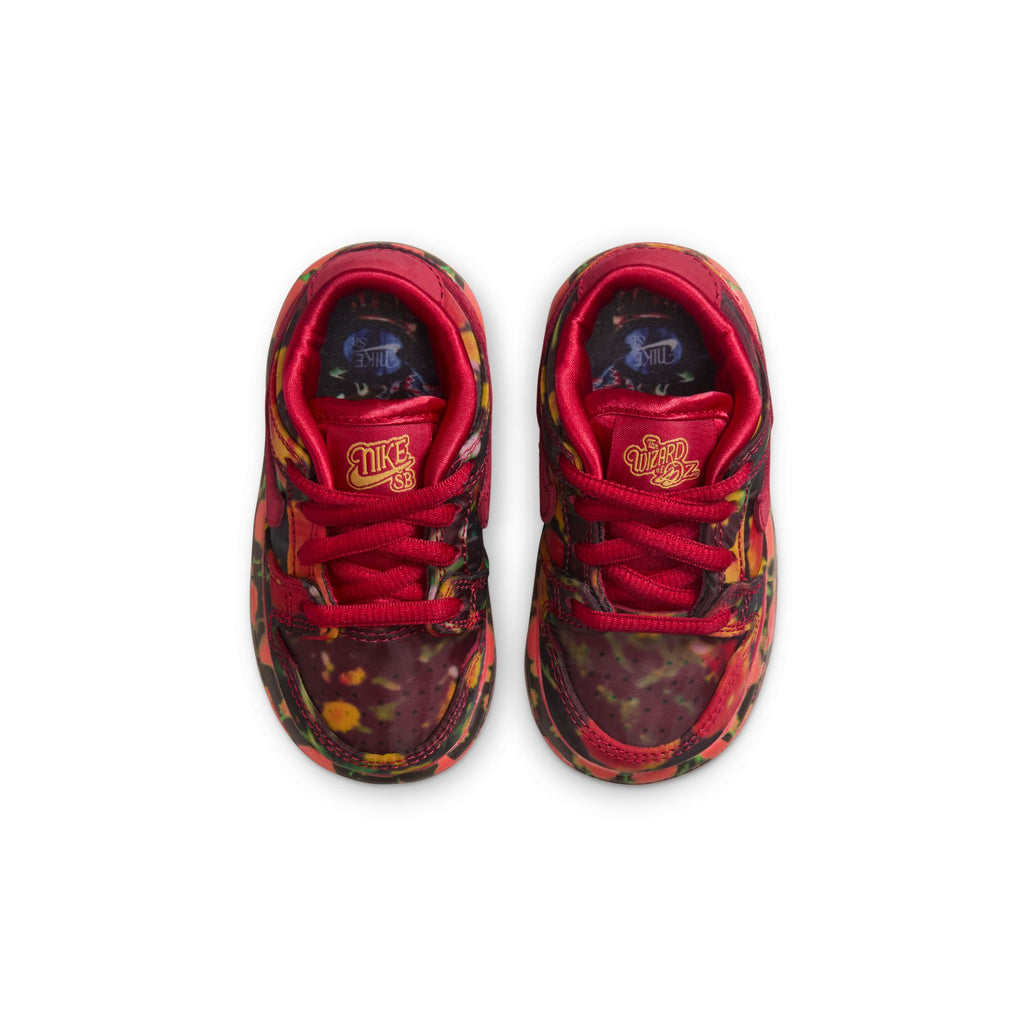 Top view of NIKE SB DUNK LOW 👠💚 TODDLER sneakers by Nike features a red design with a colorful, abstract pattern, ideal for pairing with skateboards.