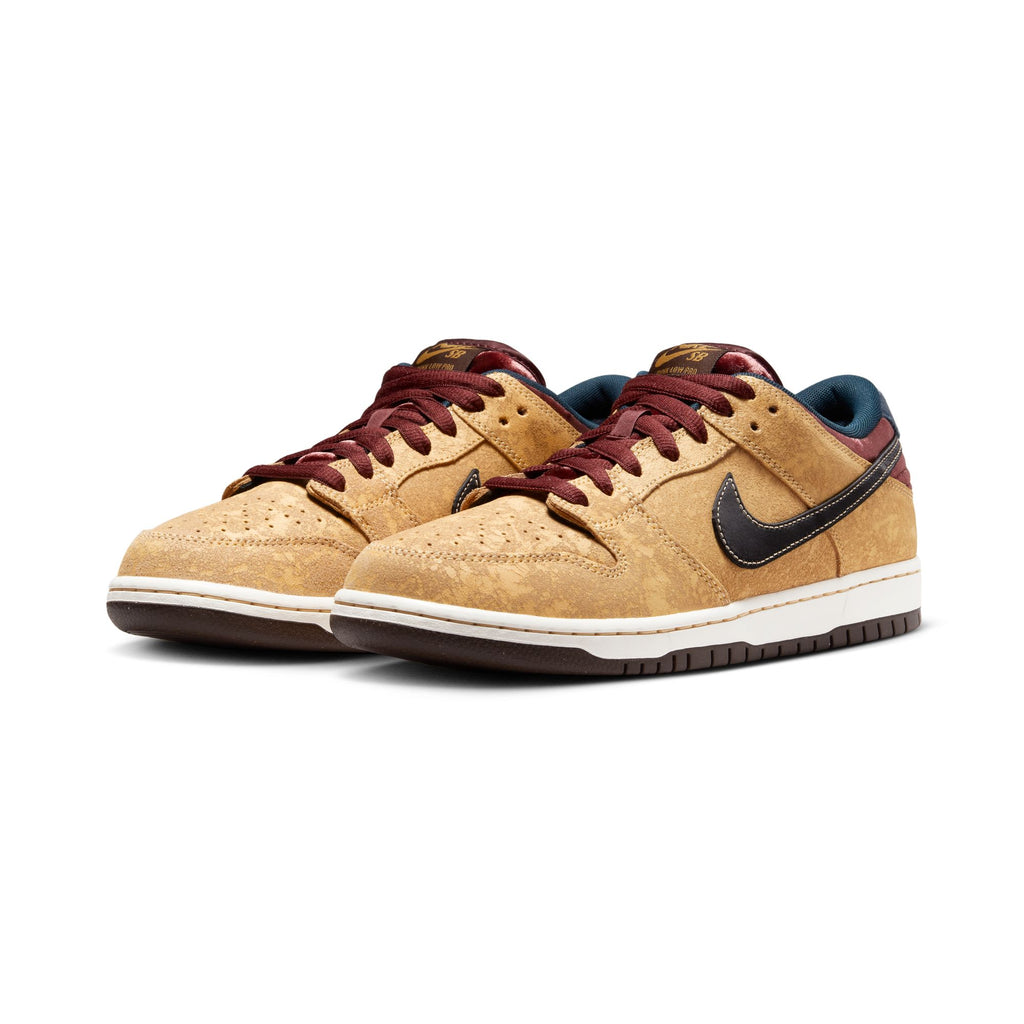 These NIKE SB DUNK LOW PRO sneakers, styled in Celestial Gold, Black, and Dark Team Red, boast a captivating blend of colors with a black swoosh logo and white midsoles, evoking the timeless elegance of Parisian cinema.