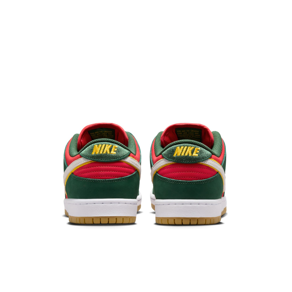 A glance at the back of the NIKE SB 💫💚 sneakers showcases their vibrant red, green, and yellow color scheme, complete with the nike logo on the heel. These sneakers are designed to provide cushioned comfort for a smooth stride.