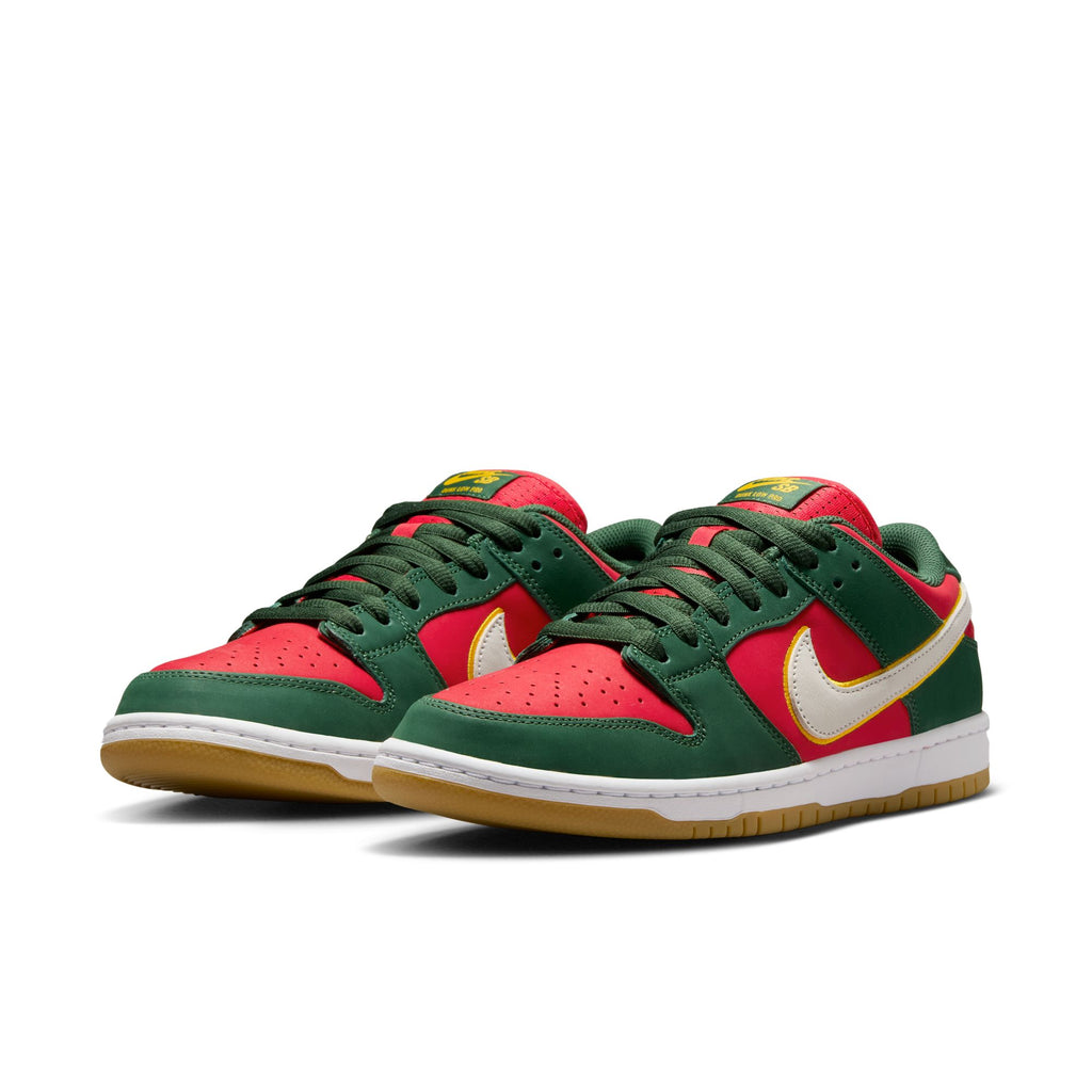 NIKE SB 💫💚 sneakers featuring a green and red color scheme with white soles and yellow swooshes, crafted from premium materials, displayed against a plain background.