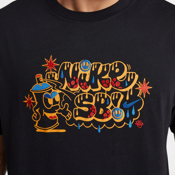 The NIKE SB MAX90 Spray Can Skate Tee Black by Nike features a vibrant graffiti-style design with "Nike SB" surrounded by stars and a cartoon character.