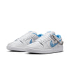 The NIKE SB X NICOLE HAUSE DUNK LOW PRO sneakers feature a white and blue design with a checkered swoosh, silver chain, unique detailing, and Air Zoom cushioning for enhanced comfort.