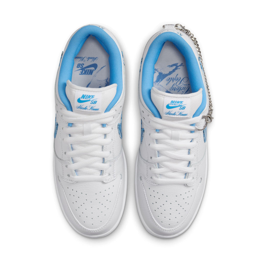 A pair of white and blue NIKE SB x Nicole Hause Dunk Low Pro sneakers featuring perforated toes, Air Zoom cushioning for enhanced comfort, and a fashionable chain accent on one shoe.