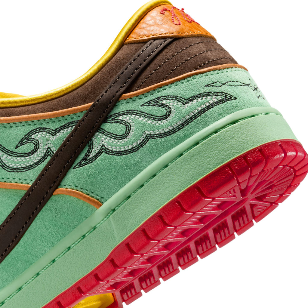 Close-up of the nike SB Rodeo Dunk Low Tourmaline/Baroque Brown-Monarch sneaker, showcasing green suede, brown and orange highlights, an embroidered wave, bright red sole, and Southwest-inspired detailing.