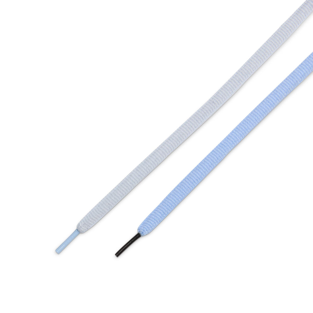 Parallel on a white background, two textured cables showcase premium craftsmanship: one in football grey with a black tip and the other in aluminum blue with a matching tip.