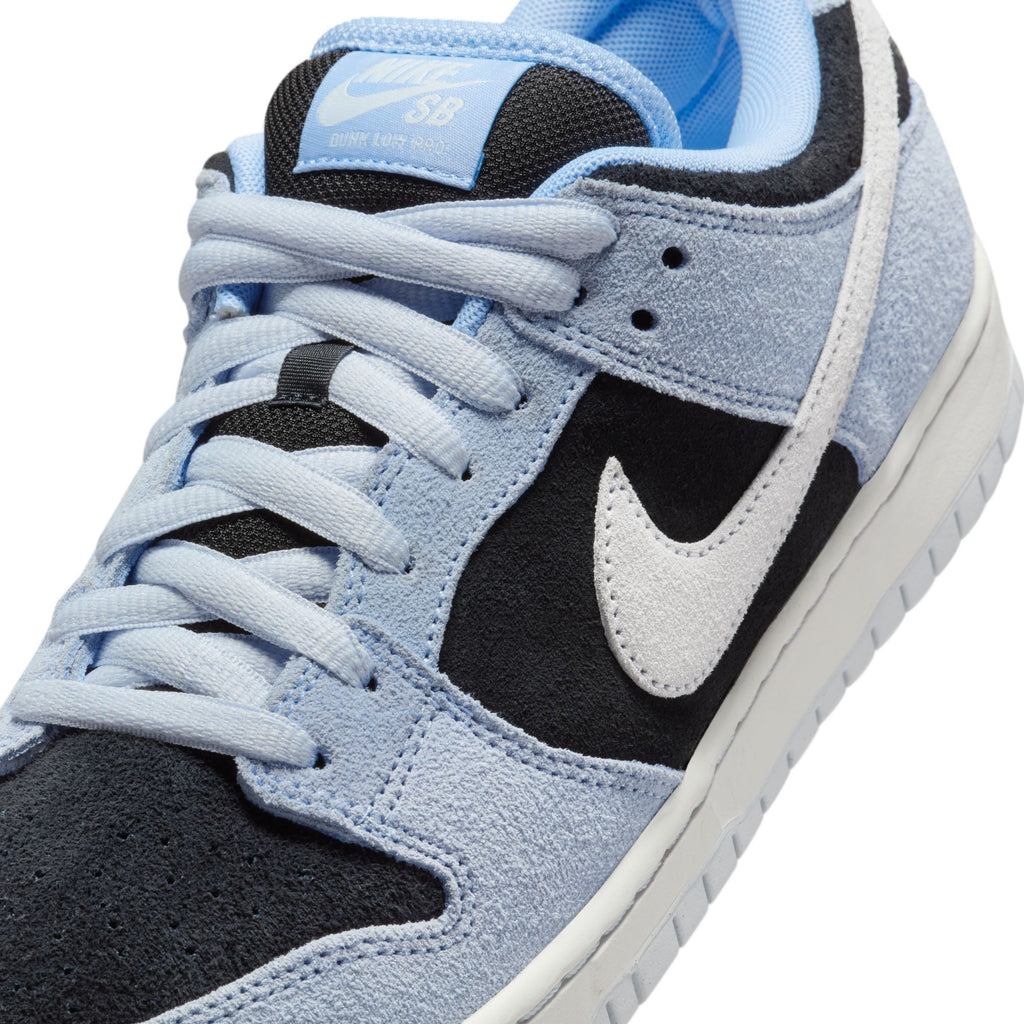 Close-up of the Nike SB Dunk Low Pro in Aluminum/Black-Football Grey, featuring a suede upper and durable traction for improved grip, with a visible Nike Swoosh logo on the side.