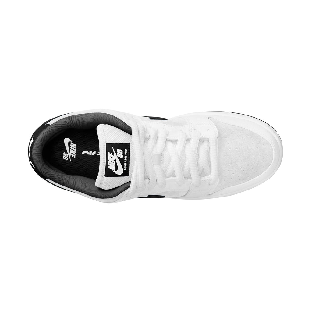 Top view of the NIKE SB DUNK LOW PRO WHITE/BLACK-WHITE-BLACK from Nike, showcasing its sleek suede upper, black interior, and white laces on a plain white backdrop. It features a durable rubber outsole for enhanced grip and style.