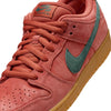 A close-up view of a Burnt Sunrise/Vintage Green nike SB Dunk Low Pro sneaker with a teal swoosh, foam midsole, and a gum sole.