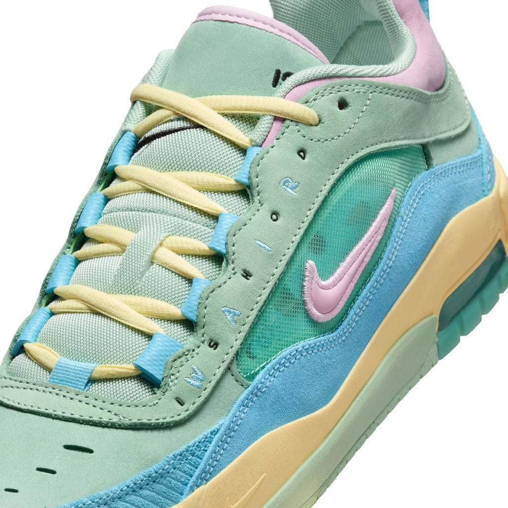 Close-up of the NIKE SB ISHOD 2 VERDY AIR MAX sneaker in Blue Gaze, Light Arctic Pink, and Enamel Green, featuring a pastel-colored mix of mint green, light blue, soft yellow, and pink accents. The shoe highlights a visible "AIR" label along with the iconic Nike swoosh logo and showcases Max Air technology for enhanced comfort and skate durability.
