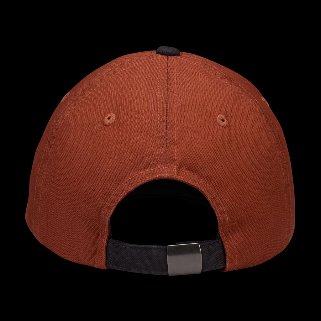 Rear view of the NIKE SB CLUB HAT CINNAMON by nike, a rust-colored cotton twill baseball cap featuring a black adjustable back strap with metal clasp, set against a black background.