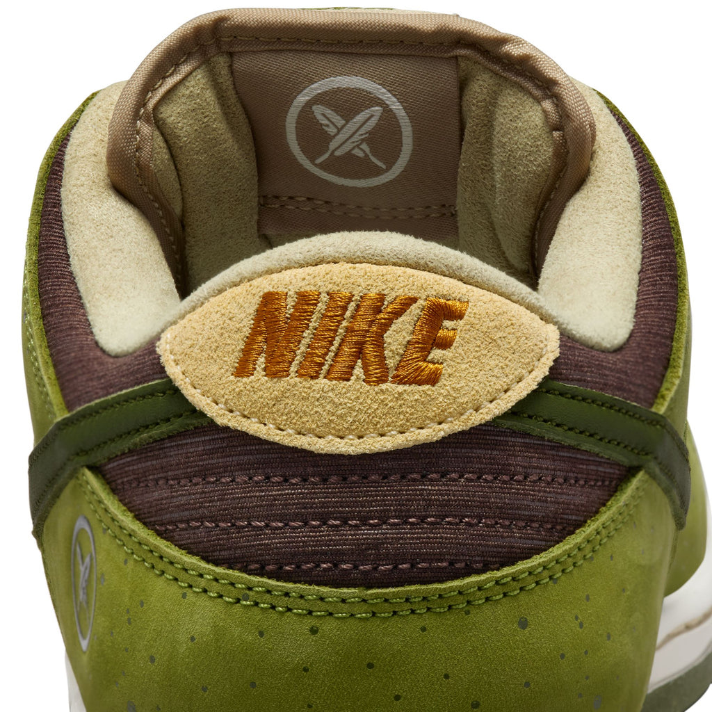Close-up of the RAFFLE WINNER NIKE SB YUTO "MATCHA" Dunk Low Pro featuring iconic branding, crafted with premium materials for durability. The sneaker flaunts a textured design in asparagus, legion green, and light khaki with a tan inner lining.