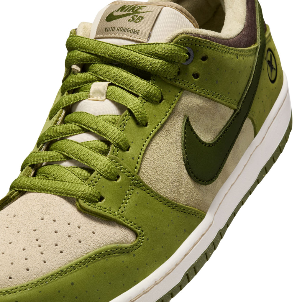 The RAFFLE WINNER NIKE SB YUTO "MATCHA" DUNK LOW PRO in asparagus/legion green-light khaki, features green laces and logo detailing. This stylish Nike shoe offers premium materials for skate performance and durable traction on every ride.