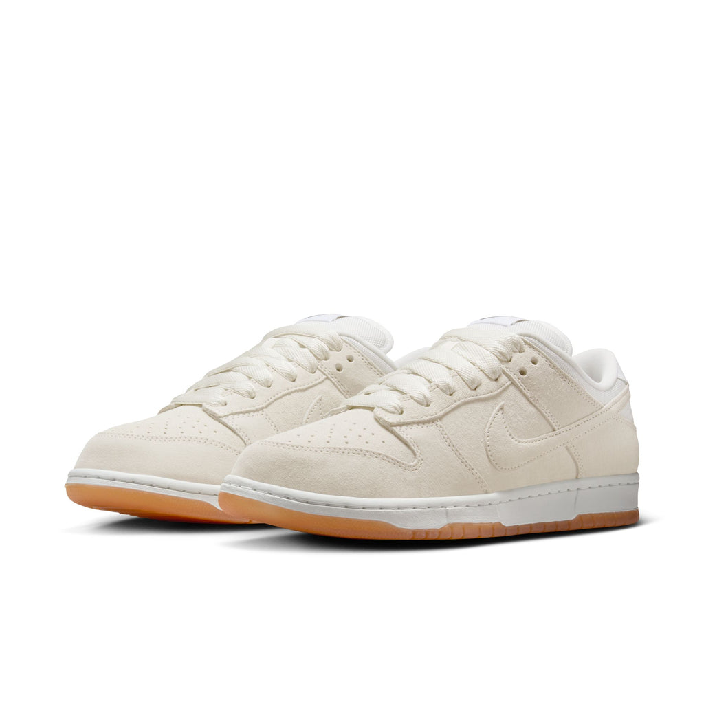 A pair of Nike SB Dunk Low Pro B in Pale Ivory/Summit White, featuring suede uppers, white midsoles, and gum rubber outsoles, displayed on a plain white background.